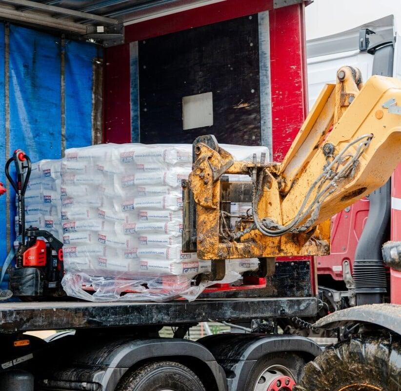 Worker loading goods onto a commercial vehicle, representing business operations and assets protected by commercial insurance